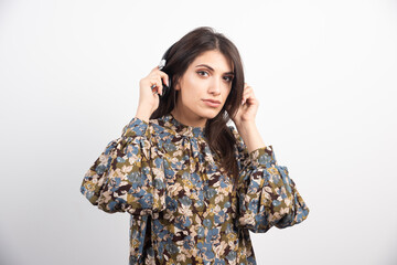 Beautiful woman listening to music with serious expression