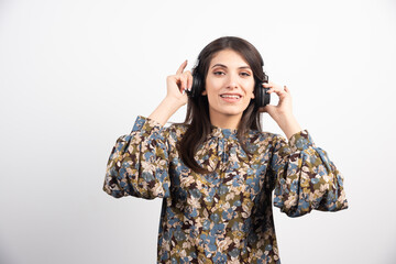 Young woman listening to music in headphones