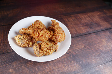 Crispy fried chicken wings on a plate top view .