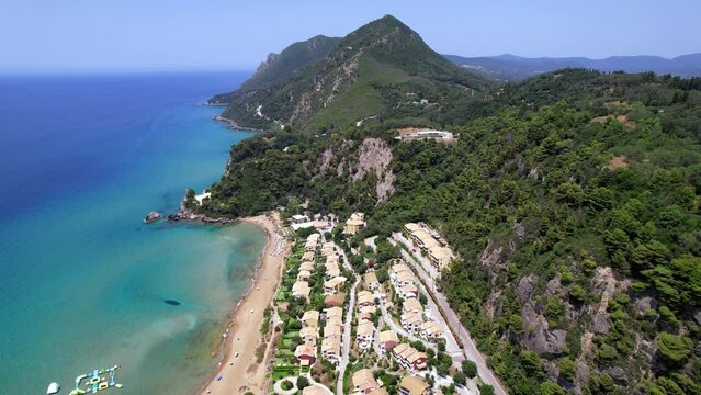Greece summer holidays. Best beaches of Corfu island. Glyfada beach and village, aerial drone view  in western part.