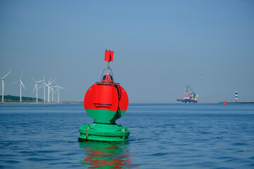 Green red buoy to mark a split in the canal Nieuwe Waterweg in the harbor of Rotterdam. - obrazy, fototapety, plakaty
