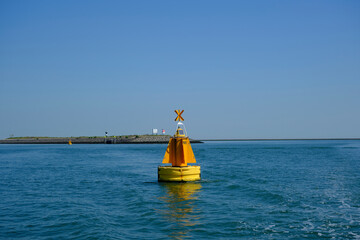 Green red buoy to mark a split in the canal Nieuwe Waterweg in the harbor of Rotterdam.