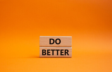 Do better symbol. Wooden blocks with words Do better. Beautiful orange background. Business and Do better concept. Copy space.