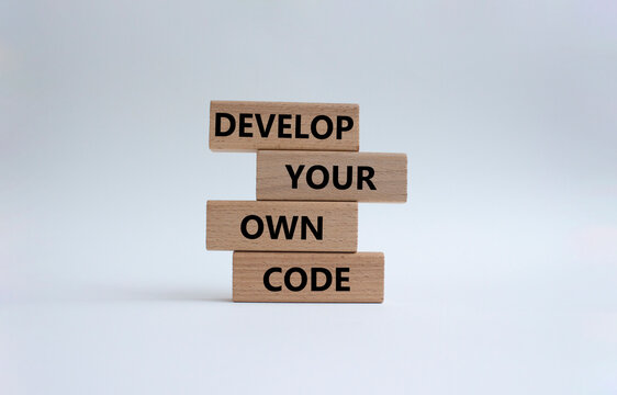 Develop your own code symbol. Concept words Develop your own code on wooden blocks. Beautiful white background. Business and Develop your own code concept. Copy space.