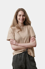 Student girl with arms crossed isolated on white background. Studio portrait of a pretty young woman smiling. People, beauty, healthy lifestyle concept.