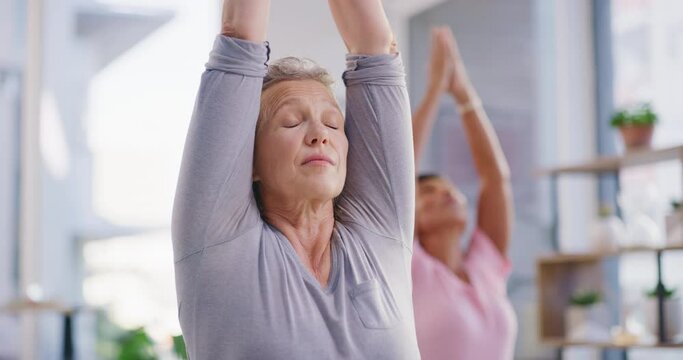 Active senior woman meditating during a fitness class in a yoga studio. Calm, relaxed and focused lady feeling zen while exercising and praying quietly for harmony, stress relief and peace of mind