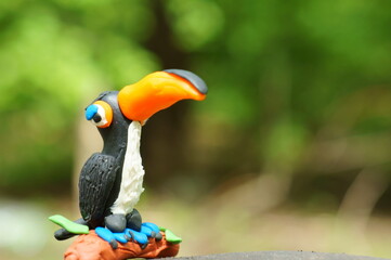 A toy toucan with an orange beak close-up. Tropical birds.