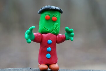 Portrait of Frankenstein close-up. A toy monster made of plasticine. Ideas for Halloween.
