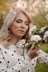 Woman portrait with eyes closed enjoying flowering spring