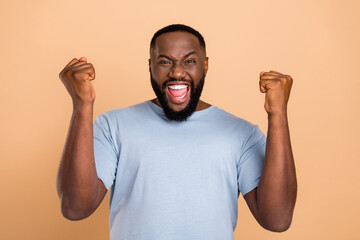 Photo of hooray young beard man yell hands fists wear outfit isolated on beige color background