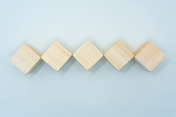 白い背景のひし形に並べたヒノキのウッドキューブ立方体5個の平面の素材