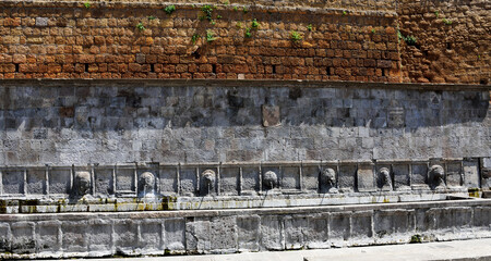 Ancient fountain of the sette cannelle located in the heart of the historic center of Tuscania