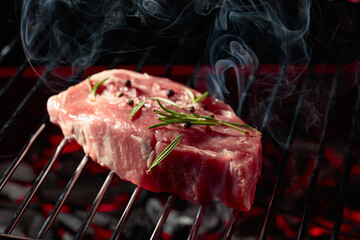 Raw steak on a grill.