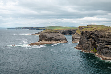 Fototapeta na wymiar A small Island and the north coast cliffs of the loophead peninsular in County Mayo