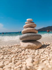 woman in blue swimsuit at the rock sunbathing