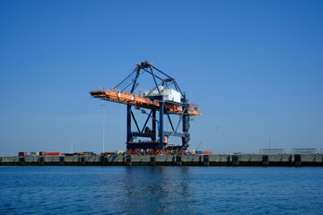 Fototapeta premium Cargo Cranes in Industrial Port, Cranes and Shipping Containers at Shipyard