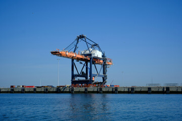 Fototapeta na wymiar Cargo Cranes in Industrial Port, Cranes and Shipping Containers at Shipyard
