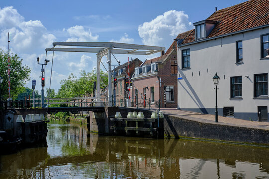 Cityscape of Oudewater, the Netherlands. Situated along the river Hollandsche IJssel. View of vintage houses, river, canal and medieval church. Province of Utrecht. Dutch skyline.