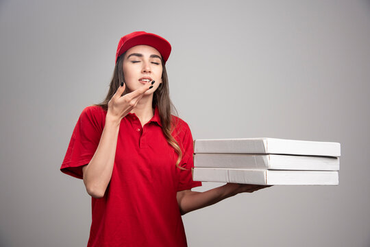 Delivery Woman Holding Pizzas Eyes Closed