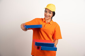 Pizza delivery woman holding pizza boxes on white background