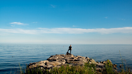 Man looking at Lake Ontario before sunset