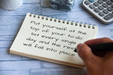 Life inspirational quote - Put yourself at the top of your to-do list every single day and the rest will fall into place. Hand writing on notepad - Powered by Adobe