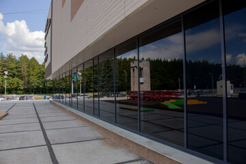 Shopping center with glazed first floor, tinted glazing black