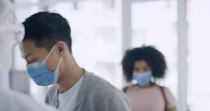 A Doctor Using A Thermometer To Measure A Patients Temperature In Cover Testing Center. A Man And Woman Wearing Masks And Getting Scanned For Corona Virus Or Monkeypox Symptoms