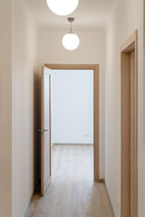 The corridor between the living rooms is illuminated by lamps in round shades.