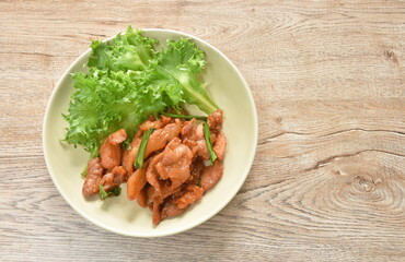 fried slice salty pork with lettuce on plate 