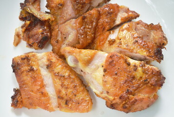 grilled slice chicken wing on plate dipping with spicy sauce