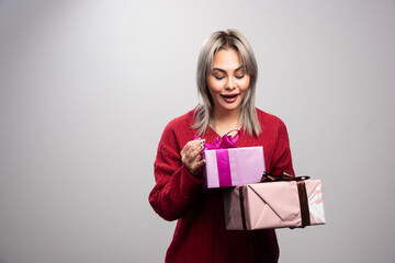 Portrait of happy woman looking at gift boxes