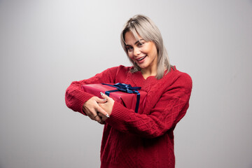 Beautiful woman feeling happy about her holiday gift