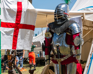 outside a camp tent of a medieval knight plate armor on a mannequin