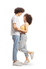 Full length profile shot of casual young couple in love hugging and looking at each other