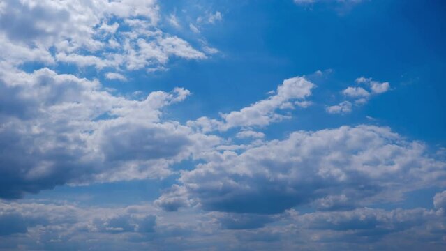 Clouds in the blue sky slowly move and change shape, Timelapse. Layered cirrus clouds dissolve in cloud space. Majestic sky. Summer cloudscape, time lapse. Change weather. Clouds background. 4K
