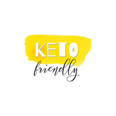 Keto friendly. Lettering on hand paint yellow watercolor texture isolated on white background. Ink dry brush stains, stroke, splash, smudge, scribble. Low carb high fat motivation quote menu poster. - 515885253