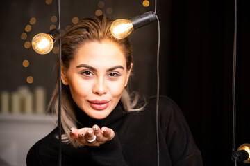 Portrait of beautiful woman blowing an air kiss