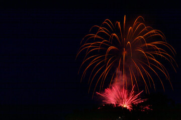 Colorful fireworks celebration in the night sky with free space for text
