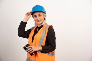 Construction worker posing with cup of tea on white background