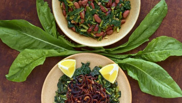 Two famous Mediterranean dish with chicory leaves. Lebanon Hindbeh Bi Zeit (chicory with olive oil) and Italian Cicoria e Fagioli (Chicory and beans). Borlotti beans aka cranberry beans aka rosecoco.
