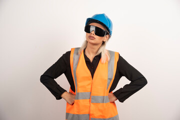 Woman builder posing with goggles and helmet