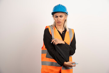 Woman industrial worker holding clipboard on white background