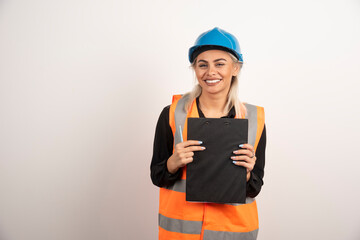 Woman industrial worker holding clipboard on white background