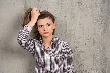 A young pretty woman holding hair in ponytail