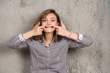 Young beautiful woman showing teeth and mouth