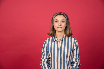 Short haired girl standing on red background