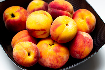 Naklejka na ściany i meble raw peaches in bowl, bowl of fresh peaches on white background