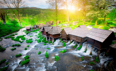 Old small wooden water mills called Mlincici by the Pliva lakes near the Jajce town in Bosnia and...