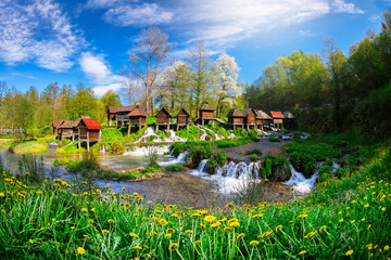 Old small wooden water mills called Mlincici by the Pliva lakes near the Jajce town in Bosnia and Herzegovina